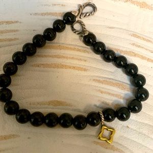 David Yurman black onyx bracelet with gold charm.